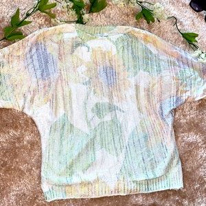 Sweater with flower in background